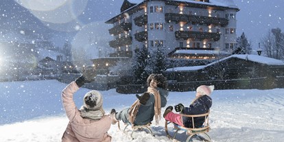 Hotels an der Piste - Skiverleih - Skigebiet Dorfgastein-Großarltal - Schlittenfahren direkt am Hotel - 4* Hotel Bergzeit 