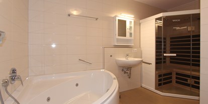 Hotels an der Piste - Trockenraum - Görwihl - Beispielbild Badezimmer mit Sauna und Whirlpoolwanne - H&P Residenz Grafenmatt