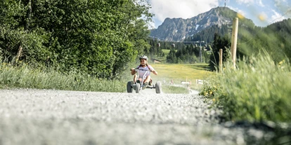 Hotels an der Piste - Verpflegung: Halbpension - Itter - Mountaincarts am Harschbichl Erlebnisberg in St. Johann in Tirol - COOEE alpin Hotel Kitzbüheler Alpen