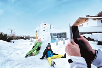 Skihotel: Spaß im Schnee auf der Hotelterrasse - amiamo - Familotel Zell am See