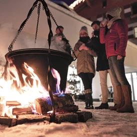 Skihotel: Begrüßung mit Glühwein und Kinderpunsch am Lagerfeuer - amiamo - Familotel Zell am See